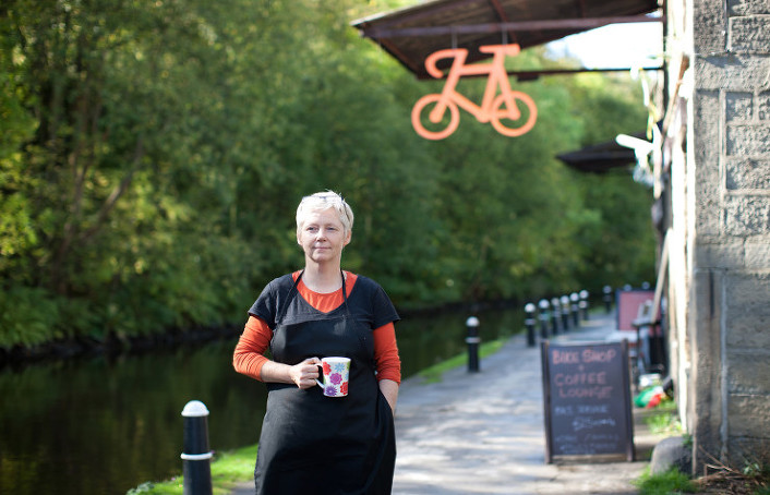Bicycle Den owner enjoying a mug of coffee