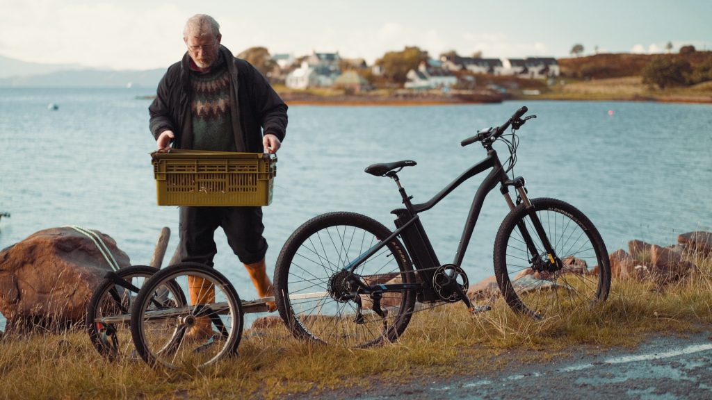 Scottish fisherman Ali Macleod carrying his catch using his VOLT Alpine e-bike
